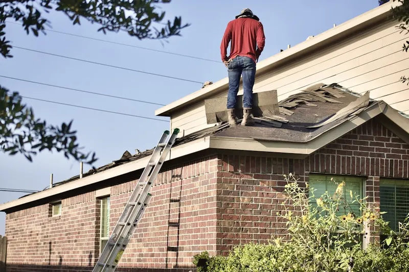 Professional roofer working on a residential roof in 9th and 9th